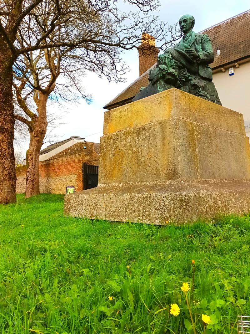 Dorset Statue of Thomas Hardy with Grass and Flowers