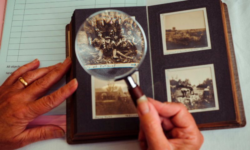 photo album with magnifying glass highlighting photo
