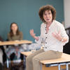 Jeanette Winterson sat on desk at writing workshop